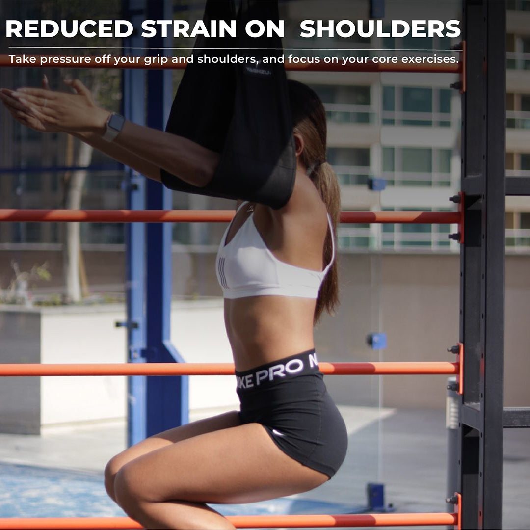 Woman using Yaghzu ab straps on pull-up bar to reduce shoulder strain during core workout. Padded hanging ab straps with reinforced stitching for gym workouts