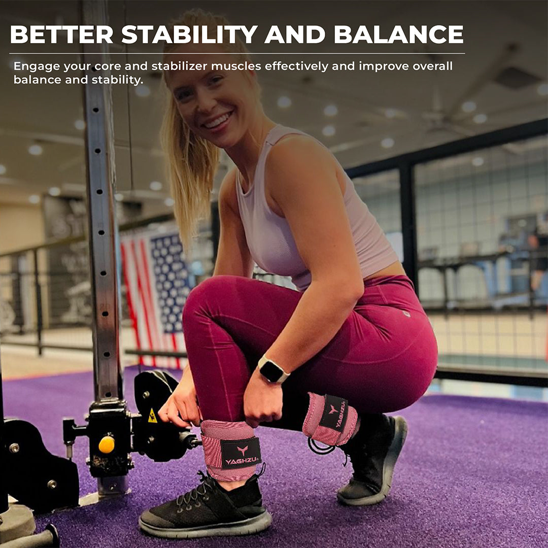 Smiling woman adjusting Yaghzu ankle straps for cable machine at gym. Durable pink cable ankle cuffs offer support for leg workouts and enhance balance and stability. Ideal wrist and ankle cuffs for effective lower body training.