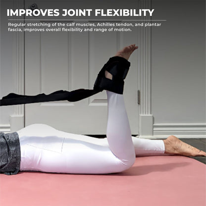 Person lying on a yoga mat using a foot and calf stretcher with yoga straps to stretch the calf muscles, Achilles tendon, and plantar fascia—ideal calf stretcher for plantar fasciitis, foot rocker stretcher, and joint flexibility improvement.
