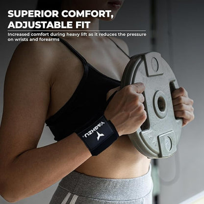 Woman wearing black Yaghzu wrist wraps while holding a weight plate, highlighting superior comfort and adjustable fit for reduced wrist and forearm pressure during heavy lifting workouts