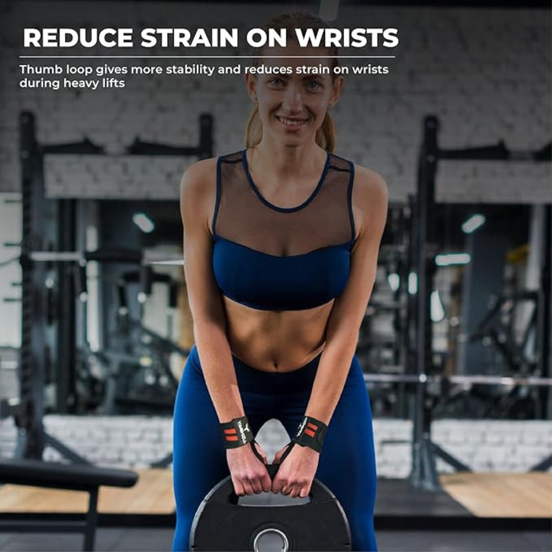 Woman lifting a weight plate in a gym wearing red Yaghzu wrist wraps, designed with a thumb loop to reduce wrist strain and enhance stability during heavy lifts