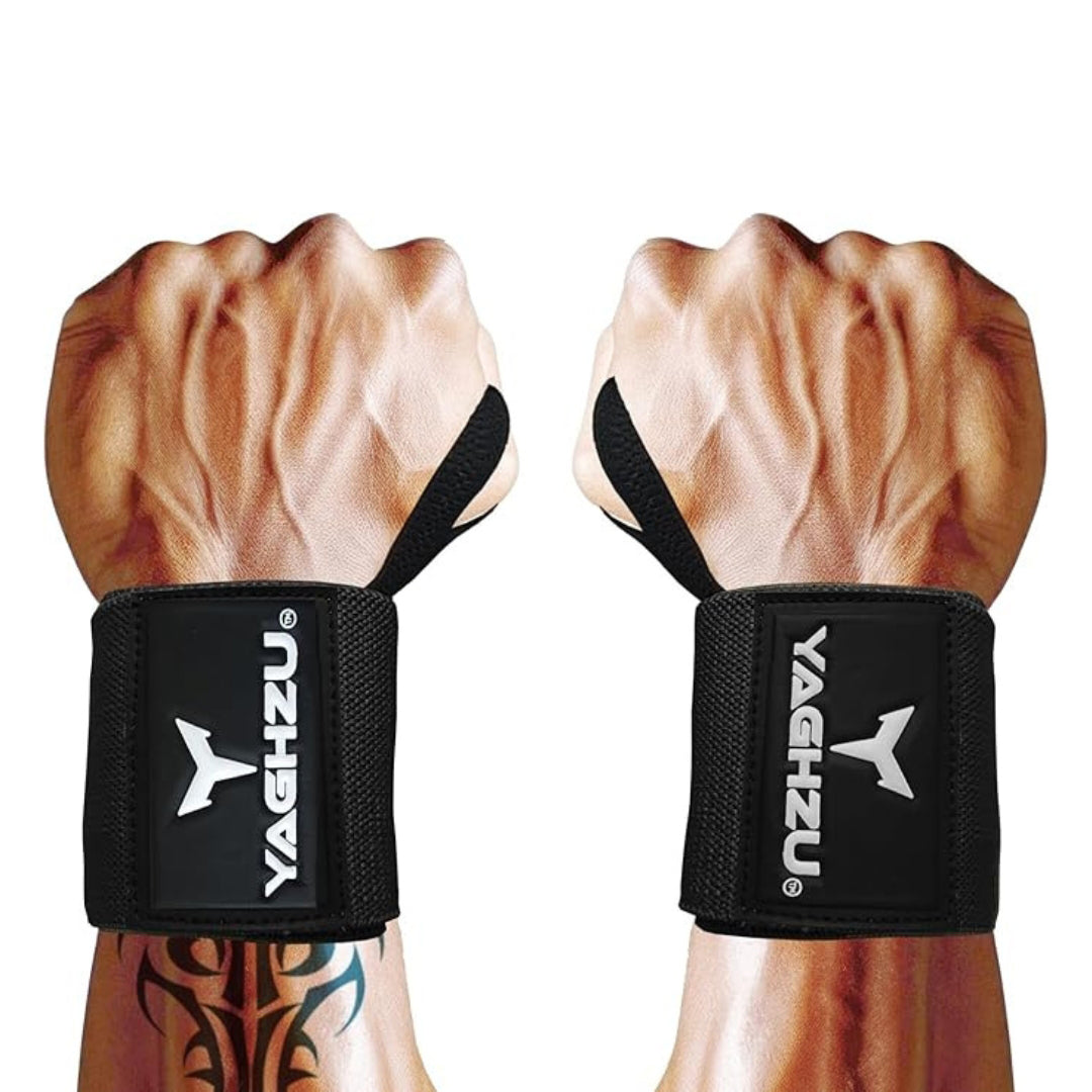 Close-up of muscular arms wearing black Yaghzu wrist wraps with thumb loops, showcasing secure fit and strong wrist support for weight lifting and strength training.